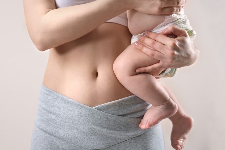 A woman carrying her baby